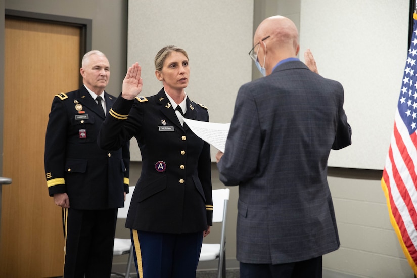 Retired Maj. Gen. Timothy Winslow administers the oath to Col. Murphy during a promotion ceremony at the Wellman Auditorium at Boone National Guard Center in Frankfort, Jul 22, 2025. Murphy has served since 1997, most recently with the Office of Special Victims’ Counsel. (U.S. Army photo by Milt Spalding)