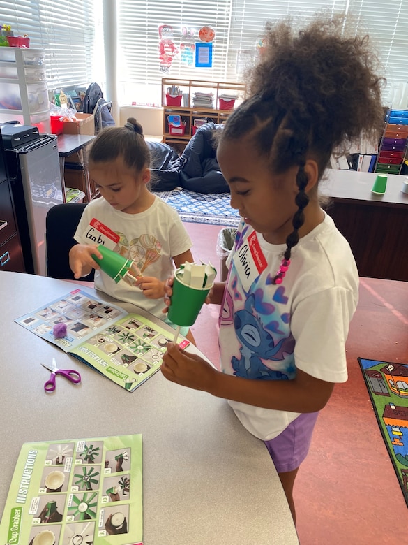 Young elementary students rotate through hands-on STEM activities that encourage creativity and curiosity.
