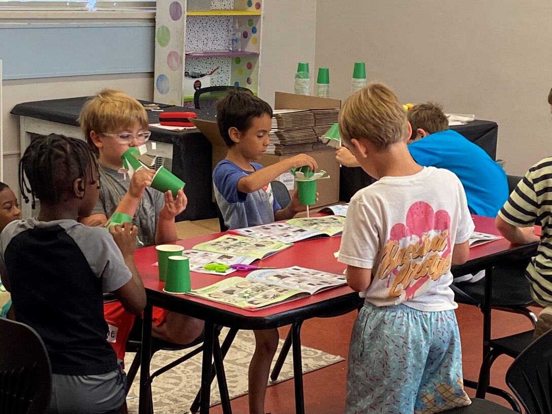 Young elementary students rotate through hands-on STEM activities that encourage creativity and curiosity.