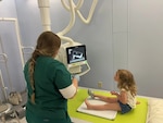 X-ray technician student Olivia Tucker at Bassett Army Community Hospital located in Fort Wainwright, Alaska, takes extra time to explain each step of 3-year-old Hazel’s cast removal to ease her fears and ensure that she feels safe before beginning medical care. Bassett was recently ranked number one for Primary Care Clinics in the Joint Outpatient Experience Survey.