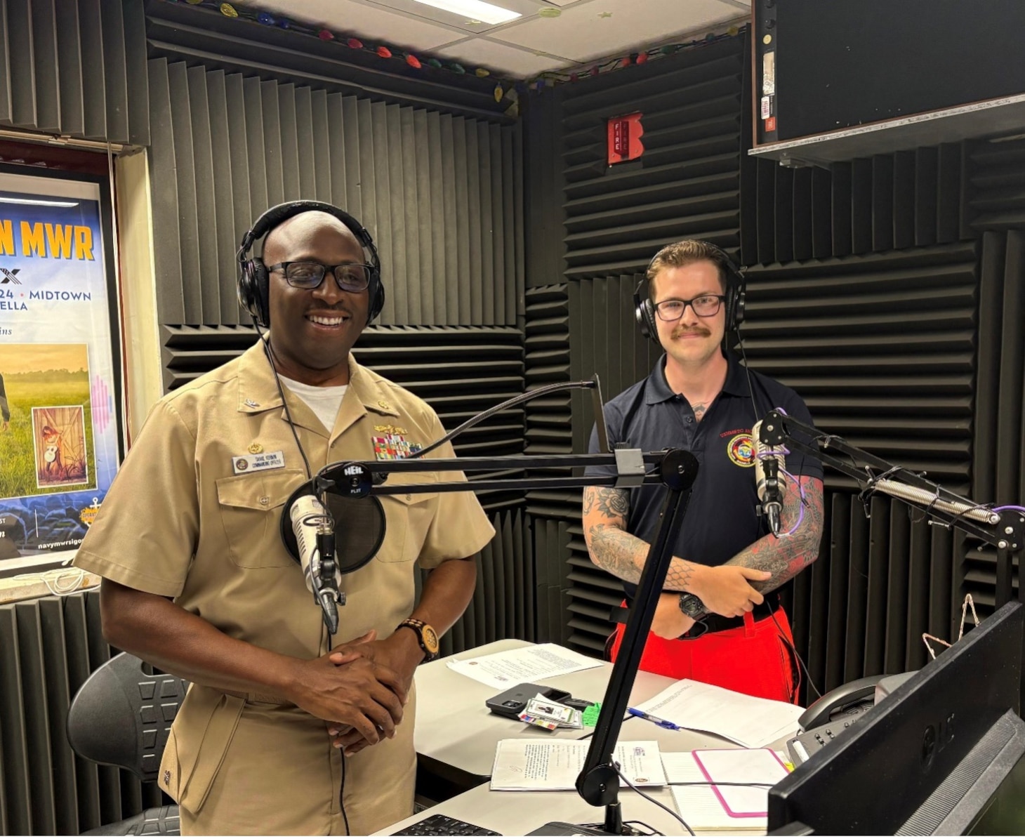 250725-N-MM059-9464 SIGONELLA, Italy. (July 25, 2025). Capt, TaRail Vernon, Director of Naval Hospital (USNH) Sigonella and Hospital Corpsman 3rd Class Brenden Sherrill, assigned to Navy Medical Readiness Training Command (NMRTC) Sigonella, prepare for Armed Forces Network (AFN) Patient Informational Minute radio segment focused on emergency care services. The segment highlighted the hospital’s 24/7 services, which is staffed by physicians, trauma-trained nurses, and EMT-certified Corpsmen who provide immediate care, triage, and coordination for life-threatening medical situations. (U.S. Navy photo by Lieutenant Junior Grade Gabriela Santesteban)