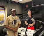 250725-N-MM059-9464 SIGONELLA, Italy. (July 25, 2025). Capt, TaRail Vernon, Director of Naval Hospital (USNH) Sigonella and Hospital Corpsman 3rd Class Brenden Sherrill, assigned to Navy Medical Readiness Training Command (NMRTC) Sigonella, prepare for Armed Forces Network (AFN) Patient Informational Minute radio segment focused on emergency care services. The segment highlighted the hospital’s 24/7 services, which is staffed by physicians, trauma-trained nurses, and EMT-certified Corpsmen who provide immediate care, triage, and coordination for life-threatening medical situations. (U.S. Navy photo by Lieutenant Junior Grade Gabriela Santesteban)