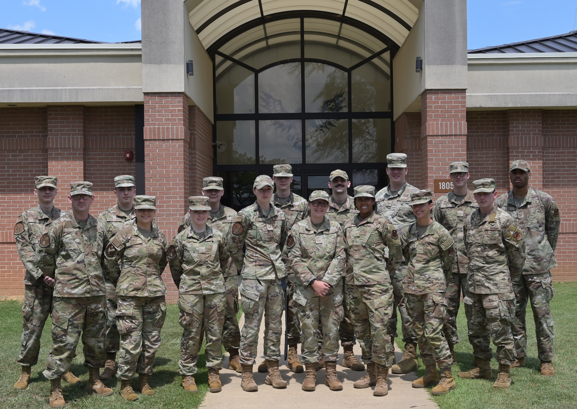 Senior Airman Cheyanne Baldini, Air Traffic Controller, poses for a photo with her team outside the RAPCON building on Columbus Air Force Base, July 30, 2025.