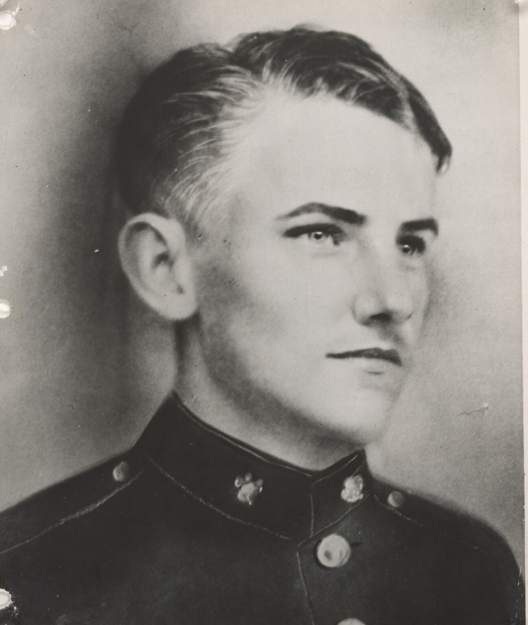 A man in uniform poses for a photo.