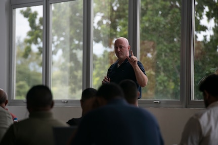 A U.S. Missouri National Guard Soldier answers a question during a cybersecurity subject matter expert exchange with local government members in Panama City, Panama, July 22, 2025. The engagement focused on building shared procedures, improving Panama’s ability to defend critical infrastructure, and preparing both nations for participation in the upcoming multinational exercise PANAMAX. (U.S. Air Force photo by Senior Airman Julia Lebens)