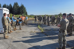 Julius A. Kolb Airman Leadership School class 25-Echo field exercise participants conduct a briefing at Joint Base Lewis-McChord, Washington, July 8, 2025.