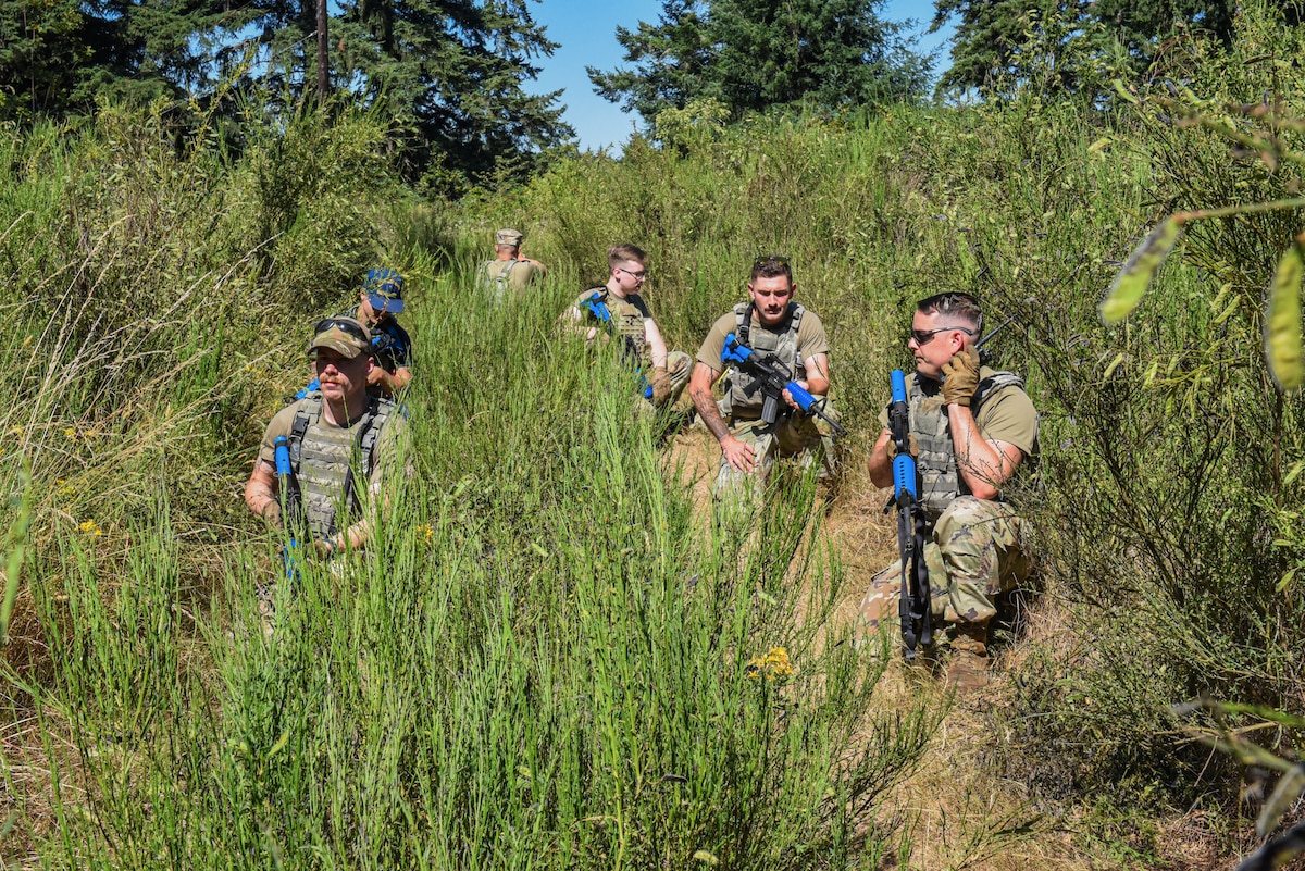 Julius A. Kolb Airman Leadership School class 25-E students patrol Base X’s perimeter during an ALS field exercise at Joint Base Lewis-McChord, Washington, July 8, 2025.