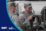 Two service members laugh together in dressed in uniform