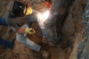 Gavin Yawn, an industrial mechanic with the 78th Civil Engineer Squadron, welds a metal plate onto a steam vent pipe at Robins Air Force Base, Georgia, July 24th, 2025