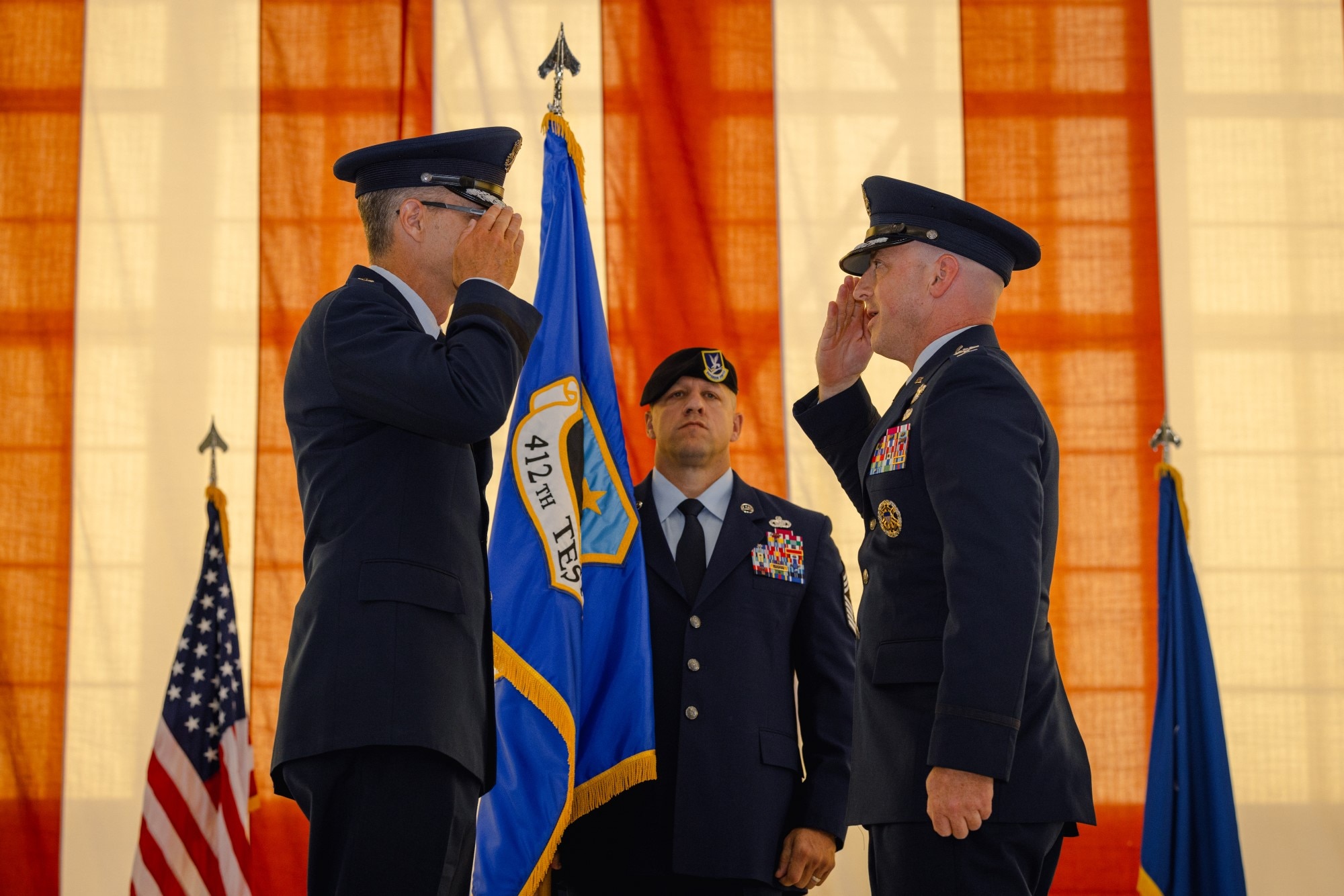 Members of the Edwards Air Force Base family gathered to take part in an age-old military ceremony July 29 as Col. Thomas Tauer assumed command of Edwards and the 412th Test Wing from Brig. Gen. Douglas Wickert. Maj. Gen. Scott Cain, Commander of the Air Force Test Center presided over the change of command ceremony, while hundreds of elected officials, family members, base employees and military members looked on. Just before passing the wing flag from Wickert to Tauer, Cain highlighted the 412th Test Wing's recent accomplishments under Wickert’s leadership, especially in a world facing increasingly complex and diverse threats.