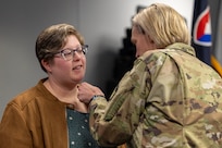 Col. Michelle M. Williams, U.S. Army Financial Management Command commander, presents a Department of the Army Civilian Service Commendation Medal to Makayla Chriss, USAFMCOM Army Accounting and Audit Operations accountant, after Chriss was announced as a U.S. Army Materiel Command Employee of the Quarter for the fourth quarter of Fiscal Year 2024 during a town hall at the Maj. Gen. Emmett J. Bean Federal Center in Indianapolis Feb. 12, 2025. In addition to her assigned accounting duties, Chriss supported the Fund Balance with Treasury team with undistributed variance analysis. (U.S. Army photo by Mark R. W. Orders-Woempner)
