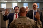 (left to right) Capt. George Bouziden and Capt. Derek Teague take the Oath of Commissioned Officers during their direct commissioning ceremony at the Armed Forces Reserve Center in Norman, Oklahoma, July 30, 2025. The two officers received their commission through a U.S. Army Talent Innovation Division program designed to identify and bring in highly skilled civilian information technology professionals to strengthen the Army’s cyber capabilities. (Oklahoma National Guard photo by Anthony Jones)