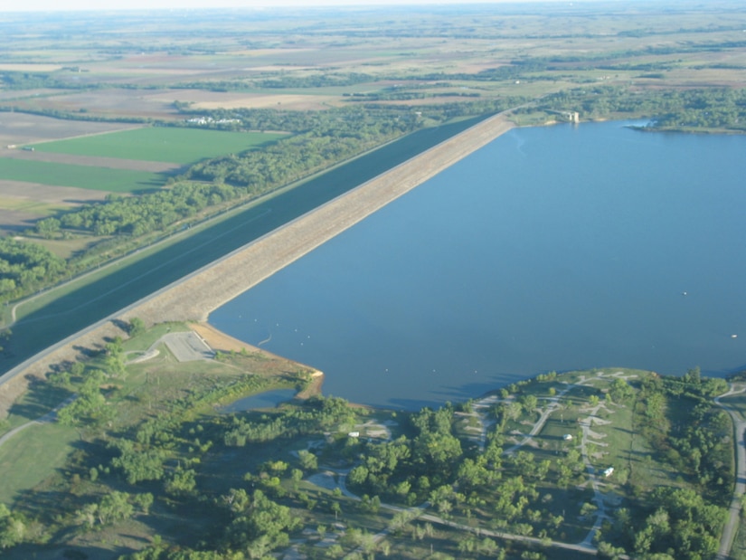 A blue body of water surrounded by green vegetation.