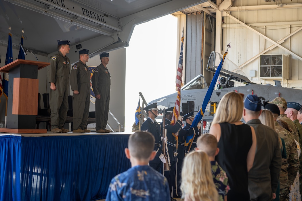 People standing during a change of command ceremony.