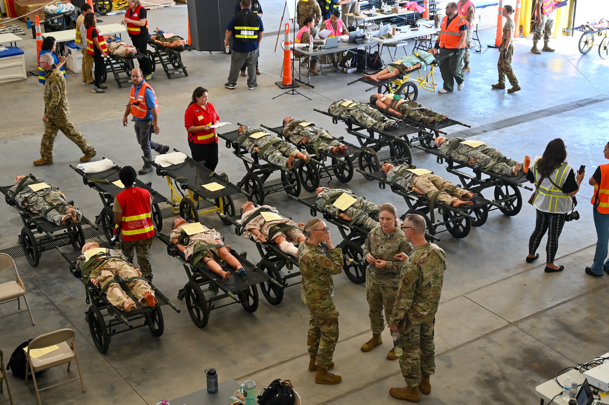 Personnel conduct medical evaluations on training mannequins