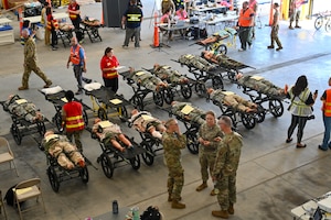 Personnel conduct medical evaluations on training mannequins