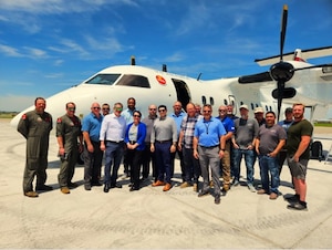 Group of people in front of aircraft