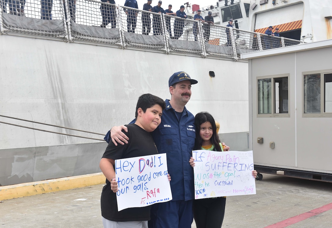 Senior Chief Petty Officer Michael Weelmaa, a U.S. Coast Guard Cutter Stratton (WMSL 752) crew member, embraces his children after returning to Stratton's Base Alameda. California, home port, July 30, 2025. Stratton completed a 134-day patrol in the Indo-Pacific. U.S. Coast Guard photo by Petty Officer 3rd Class Danish Khan.