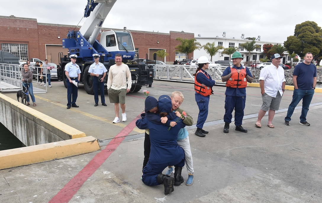 Children reunite with their mother stationed aboard the U.S. Coast Guard Cutter Stratton (WMSL 752) as the cutter returns home to Base Alameda, California, July 30, 2025, following a 134-day Western Pacific patrol. The namesake of the U.S. Coast Guard Cutter Stratton is Capt. Dorothy Stratton, who led the service’s all-female reserve force during World War II. U.S. Coast Guard photo by Petty Officer 3rd Class Danish Khan.