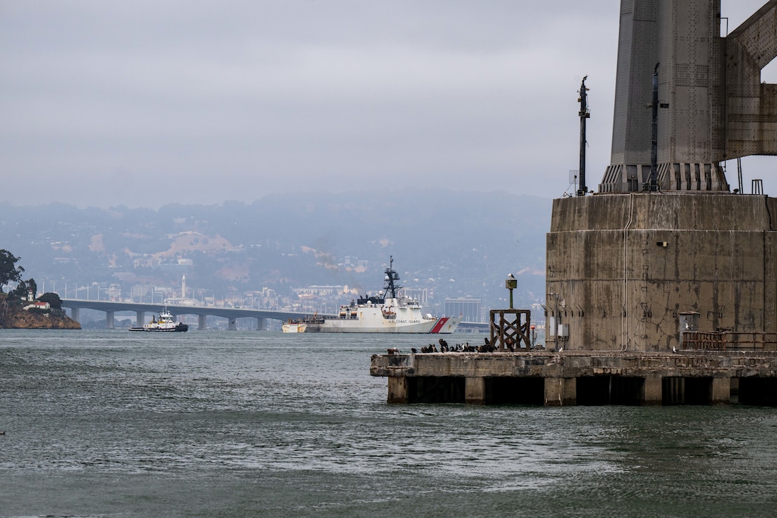 U.S. Coast Guard Cutter Stratton (WMSL 752) makes its way toward Coast Guard Island after crossing underneath the Bay Bridge in San Francisco Bay, July 30, 2025. National security cutters routinely conduct operations throughout the Pacific, where their unmatched combination of range, speed, and ability to operate in extreme weather provides the mission flexibility necessary to conduct vital strategic missions. (U.S. Coast Guard photo by Petty Officer 3rd Class Austin Wiley)