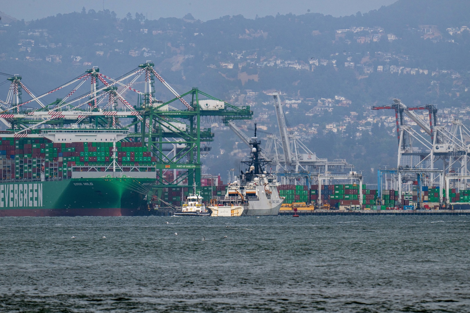 U.S. Coast Guard Cutter Stratton (WMSL 752) steams past the Port of Oakland on its way towards Coast Guard Island during the ship's return to home port, July 30, 2025. Stratton’s deployment contributed to regional cooperation and enhanced global maritime governance through integrated deterrence and strengthened partnerships. (U.S. Coast Guard photo by Petty Officer 3rd Class Austin Wiley)