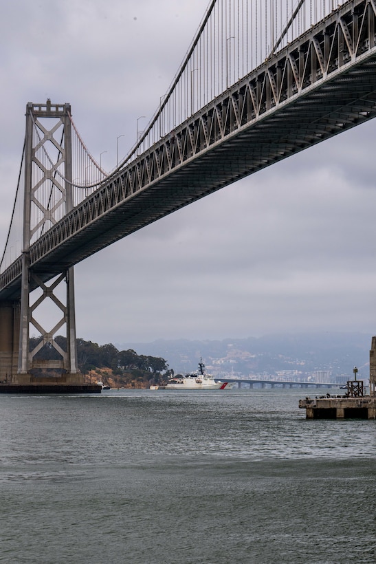 U.S. Coast Guard Cutter Stratton (WMSL 752) crosses under the Bay Bridge while transiting toward its Base Alameda, California, home port following a 134-day Western Pacific patrol, July 30, 2025. Commissioned in 2012, Stratton is one of ten Legend-class national security cutters and one of four homeported in Alameda. (U.S. Coast Guard photo by Petty Officer 3rd Class Austin Wiley)