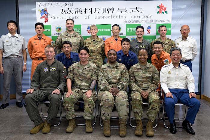 U.S. Air Force assigned to the 374th Airlift Wing and Okutama Fire Department personnel pose for a photo during a certificate of appreciation ceremony in Okutama, Japan, July 30, 2025. Events like these demonstrate the enduring partnership between Yokota Air Base and surrounding Japanese communities, built on trust, shared experiences, and mutual support