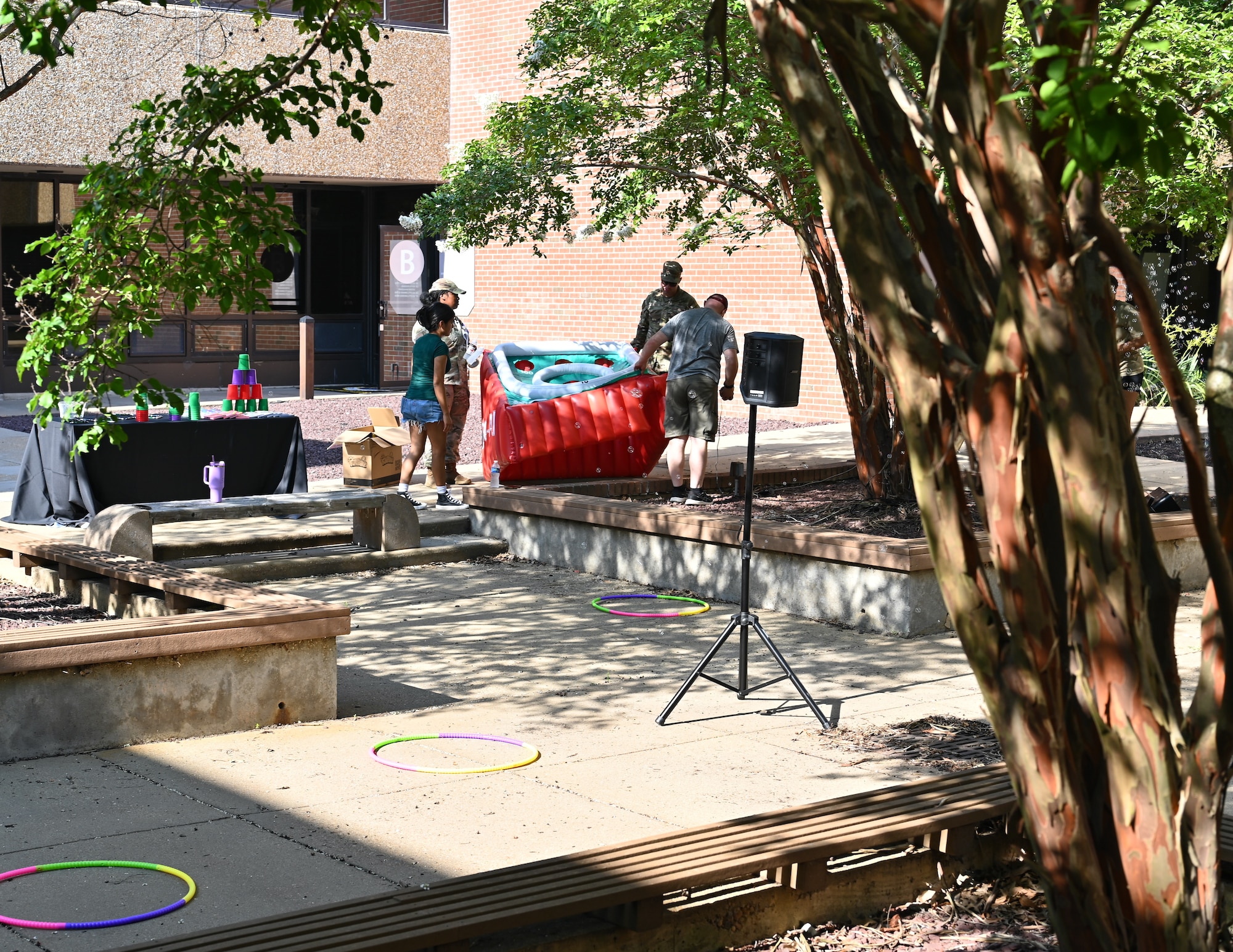 People setting up outdoor games for a BBQ.