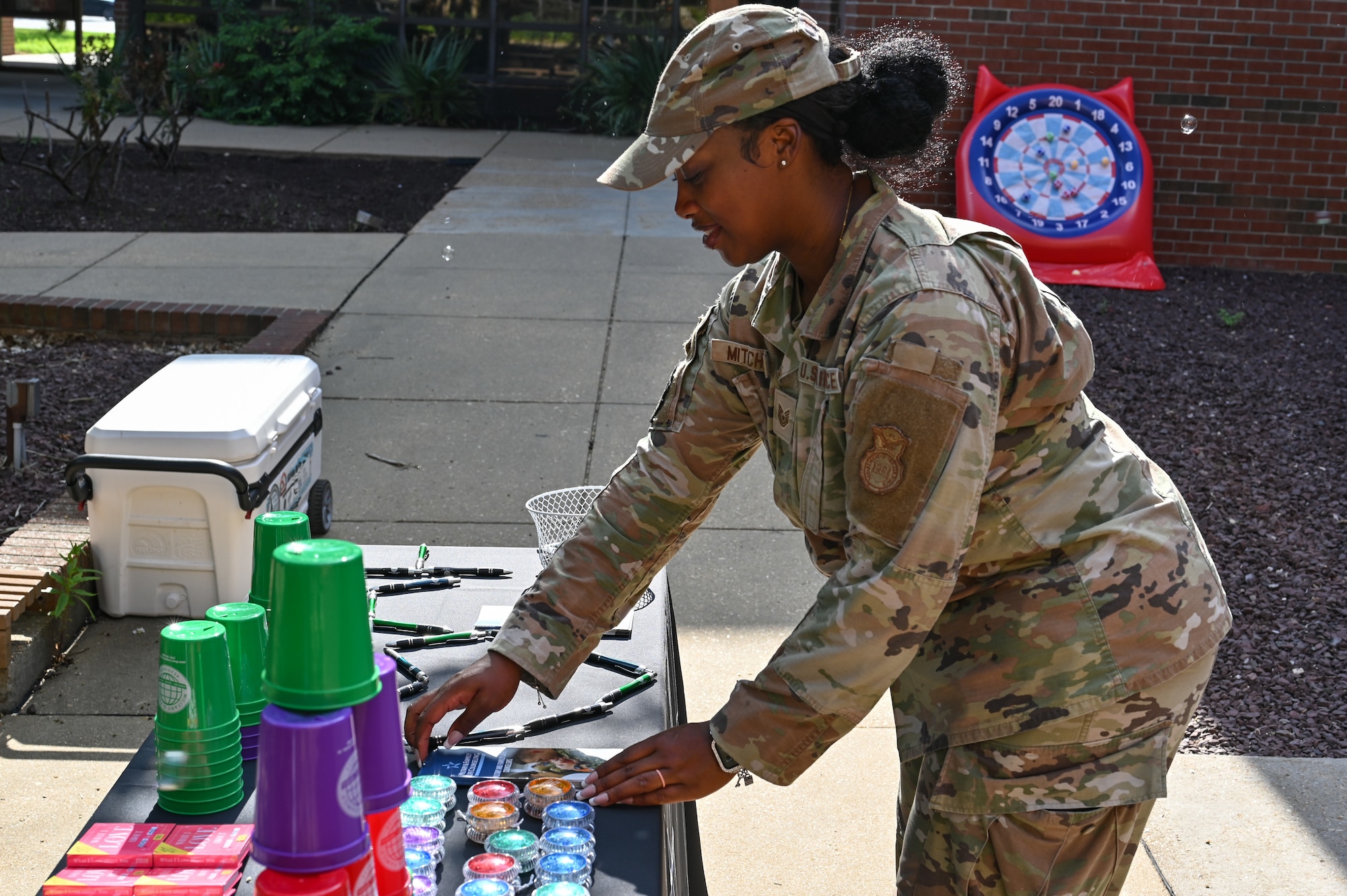 Person in uniform places things on a table.