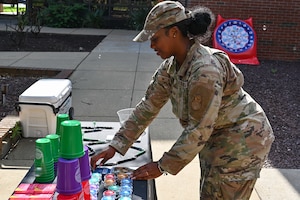 Person in uniform places things on a table.