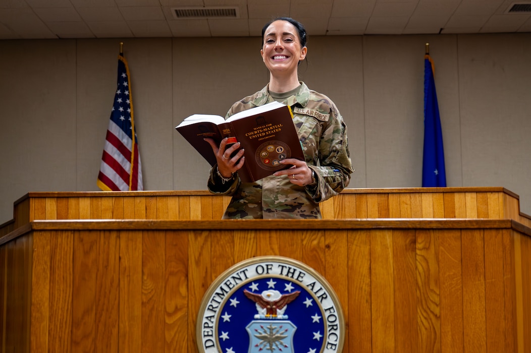 Tech. Sgt. Lacey Eakin, 8th Fighter Wing Staff Judge Advocate Office noncommissioned officer in charge of military justice, poses for a photo in the courtroom