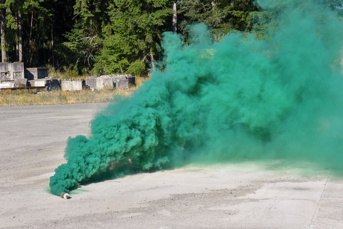 A smoke grenade is deployed during a Julius A. Kolb Airman Leadership School field exercise at Joint Base Lewis-McChord, Washington, July 8, 2025.