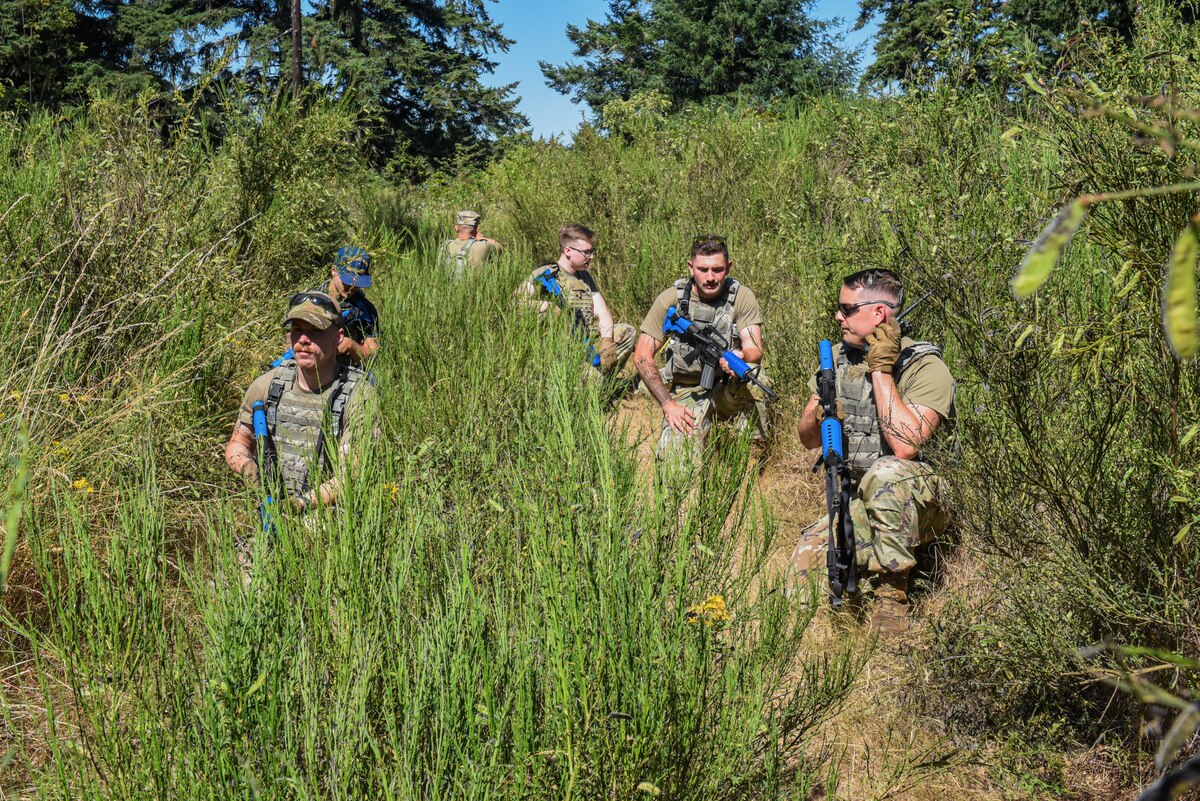 Julius A. Kolb Airman Leadership School class 25-E students patrol Base X’s perimeter during an ALS field exercise at Joint Base Lewis-McChord, Washington, July 8, 2025.