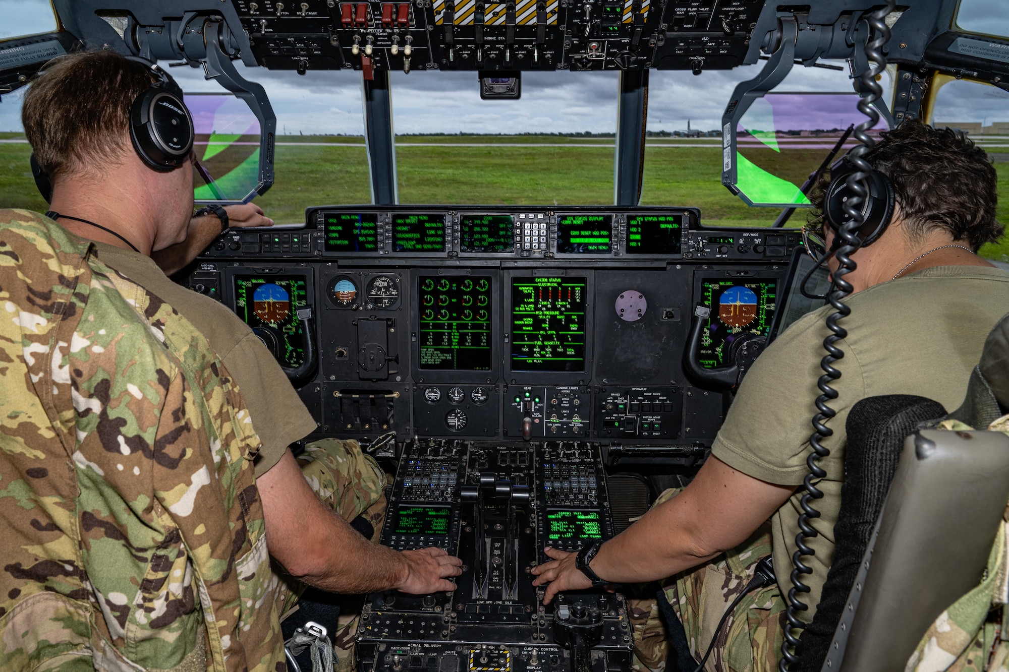 Two pilots prepare to fly an aircraft.