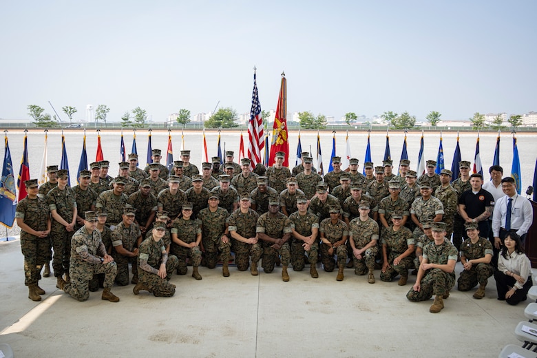 U.S. Marines, a Sailor and Korean government support employees with U.S. Marine Corps Forces, Korea pose for a photo during the MARFORK 30th anniversary and colors and rededication ceremony at U.S. Army Garrison Humphreys, South Korea, May 29, 2025. MARFORK was activated on June 1, 1995, at Seoul, Republic of Korea to support U.S. Marine Corps operations, strengthen interoperability with the Republic of Korea Marine Corps and serve as the U.S. Marine Corps service component for United States Forces Korea and United Nations Command. (U.S. Marine Corps photo by Cpl. Nikolas Mascroft)