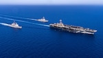 The Nimitz-class aircraft carrier USS Harry S. Truman, right, the Arleigh Burke-class guided-missile destroyer USS Jason Dunham (DDG 109), center, and the Ticonderoga-class guided-missile cruiser USS Gettysburg (CG 64) sail in the Mediterranean Sea.