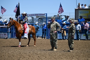 U.S. Space Force Lt. Gen Douglas A. Schiess, U.S. Space Forces - Space commander and Combined Joint Force Space Component commander, speaks to the crowd at the Santa Maria Elks Rodeo in Santa Maria, Calif., June 1, 2025. Schiess and Col. Mark A. Shoemaker, Space Launch Delta 30 commander, accompanied by their senior enlisted leaders, opened the event as guest speakers for the Military Appreciation Day at the rodeo. (U.S. Space Force photo by Staff Sgt. Joshua LeRoi)
