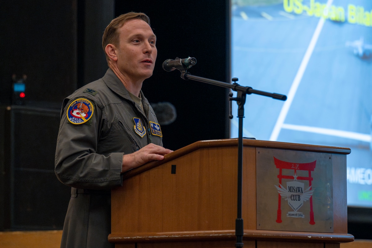 U.S. Air Force Col. Paul Davidson, 35th Fighter Wing (FW) commander, delivers opening remarks before Japan Air Self-Defense Force Lt. Gen. Hiroshi Kameoka, Northern Air Defense Force commander, takes the stage during an all-call at Misawa Air Base, Japan, May 23, 2025.