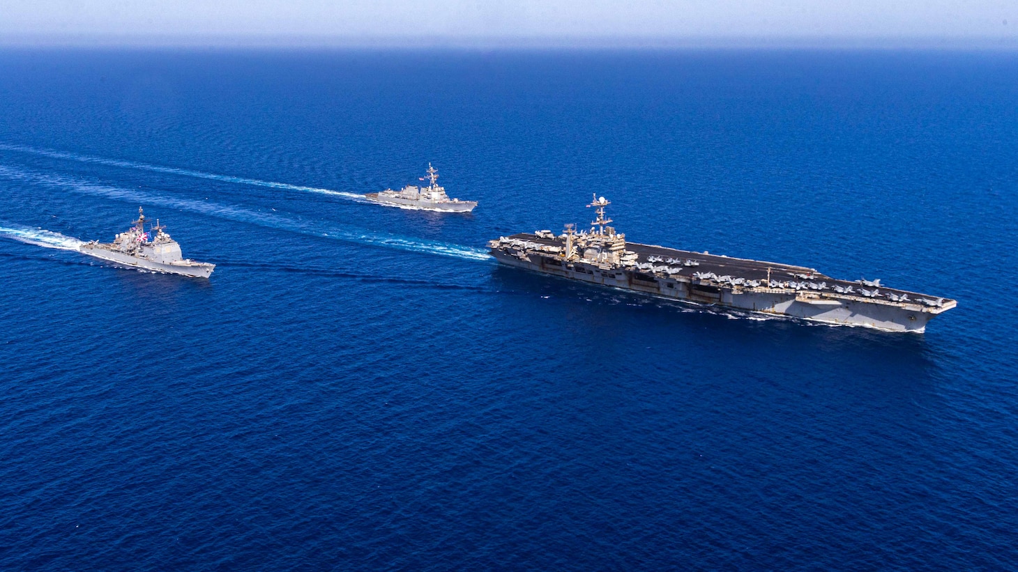The Nimitz-class aircraft carrier USS Harry S. Truman, right, the Arleigh Burke-class guided-missile destroyer USS Jason Dunham (DDG 109), center, and the Ticonderoga-class guided-missile cruiser USS Gettysburg (CG 64) sail in the Mediterranean Sea.