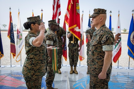 U.S. Marine Corps Sgt. Natalie Cesar, a legal services specialist with U.S. Marine Corps Forces Korea, presents a meritorious unit commendation streamer to Maj. Gen. William E. Souza III, commander of MARFORK, during the MARFORK 30th anniversary and colors and rededication ceremony at U.S. Army Garrison Humphreys, South Korea, May 29, 2025. MARFORK was activated on June 1, 1995, at Seoul, Republic of Korea to support U.S. Marine Corps operations, strengthen interoperability with the Republic of Korea Marine Corps and serve as the U.S. Marine Corps service component for United States Forces Korea and United Nations Command. (U.S. Marine Corps photo by Cpl. Nikolas Mascroft)
