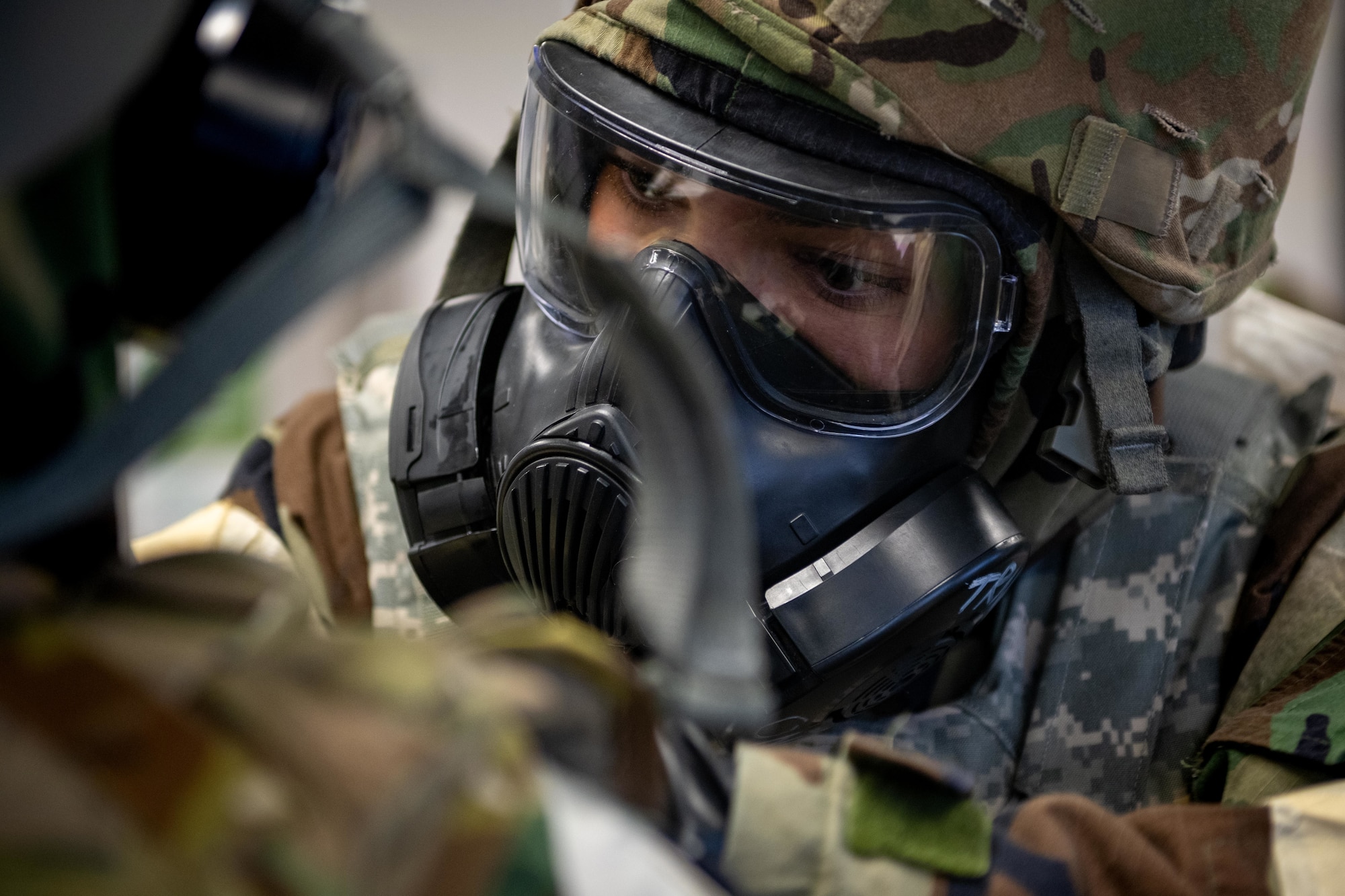 Airmen perform buddy checks of MOPP gear.
