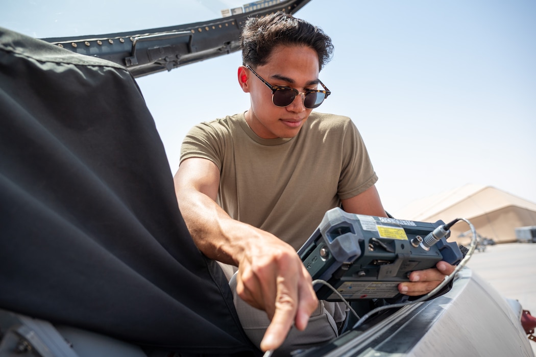 Airman uses a probe with an eddy current machine to test the canopy seal of an F-16