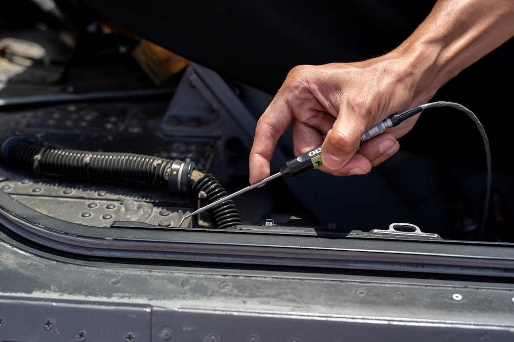 Airman uses a probe with an eddy current machine on the canopy seal of an F-16
