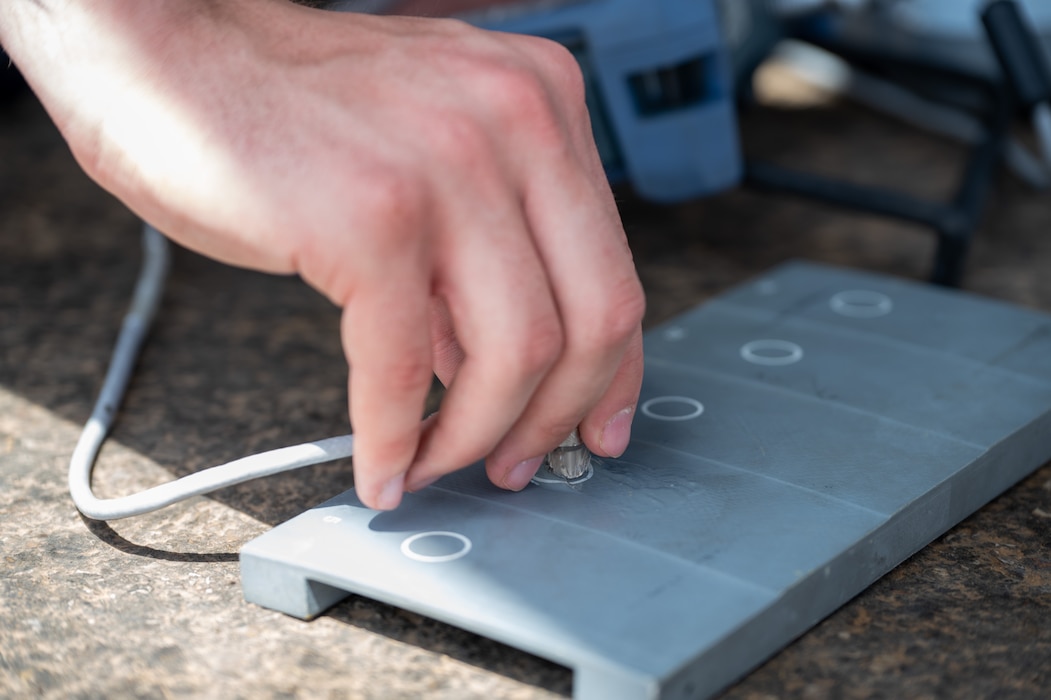 Airman uses water based couplant on a metal sheet