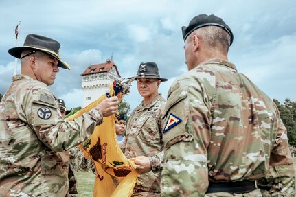 U.S. Army Col. Donny Hebel and Command Sgt. Maj. Charles Haynes, 278th Armored Cavalry Regiment, Tennessee National Guard, uncase the regimental colors at the transfer of authority ceremony at Tower Barracks, Grafenwoehr, Germany, June 1, 2025.