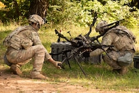 U.S. Army Specialist Nicholas Chiara (left), a unmanned aircraft system operator, and Staff Sgt. Richard Levanti, a unmanned aircraft system operator, assigned to 2-7 Infantry Battalion inspect the carrier H6 during Combined Resolve 25-2 in Hohenfels, Germany, May 20, 2025.