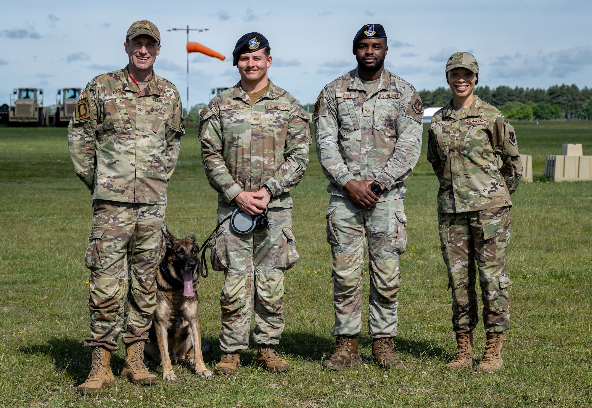U.S. Airmen from the 100th Security Forces Squadron pose for a photo with the 100th Air Refueling Wing command team after a Day in the Life integration with the 100th SFS at RAF Mildenhall, England, May 30, 2025.