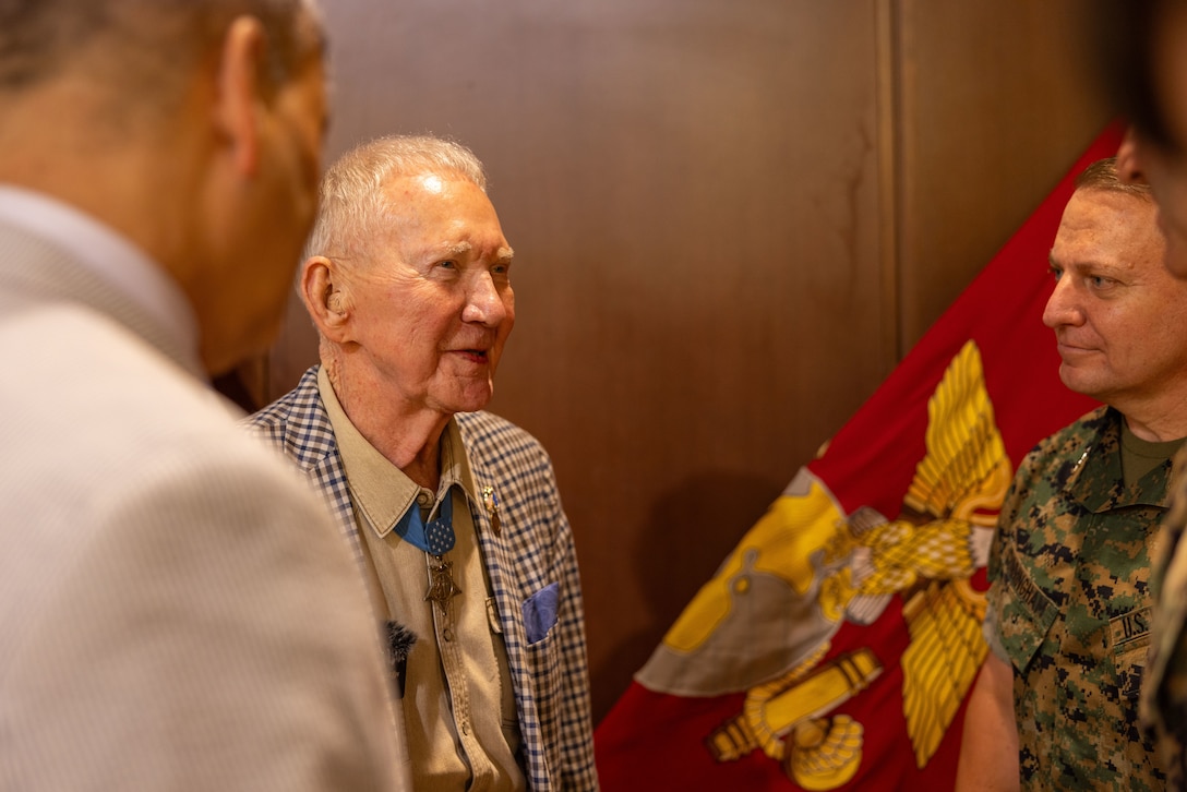 Retired U.S. Marine Corps Maj. Gen. James Livingston, center, Medal of Honor recipient and first commander of Marine Forces Reserve, speaks to Maj. Gen. Mark Cunningham, commanding general, Force Headquarters Group, Marine Forces Reserve, and other senior leaders during his visit to Marine Corps Support Facility, New Orleans, May 30, 2025. Livingston served as the first commander of Marine Forces Reserve from July 1992 to October 1994. (U.S. Marine Corps photo by Lance Cpl. Juan Diaz)