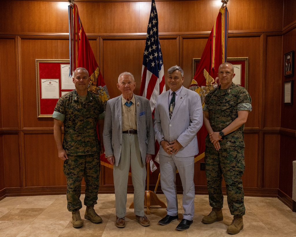 U.S. Marine Corps Col. Joshua Izenour, left, chief of staff, Marine Forces Reserve, retired Maj. Gen. James Livingston, second from left, Medal of Honor recipient and first commander of Marine Forces Reserve, Gregg Habel, second from right, Deputy Director of Marine Forces Reserve, and Col. Jeffrey Hammond, chief of staff, Marine Forces South, poses for a photo during his visit to Marine Corps Support Facility, New Orleans, May 30, 2025. Livingston served as the first commander of Marine Forces Reserve from July 1992 to October 1994. (U.S. Marine Corps photo by Lance Cpl. Juan Diaz)
