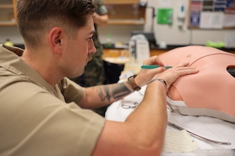 U.S. Navy Hospital Corpsman 3rd Class Garrett Whittemore, a field medical service technician with 2nd Medical Battalion, and a native of Ocean Springs, Mississippi, cuts open a simulated patient at Marine Corps Base Camp Lejeune, North Carolina, May 30, 2025. Whittemore’s command selected him for warrior of the week for his work ethic, high standard of patient care, and his constant hunger to learn more, constantly pushing himself, his peers and his superiors to better themselves. Each week, 2nd MLG recognizes one outstanding Marine or Sailor that goes above and beyond in their duties and embodies the qualities of an outstanding service member. (U.S. Marine Corps Photo by Cpl. Jessica J. Mazzamuto)